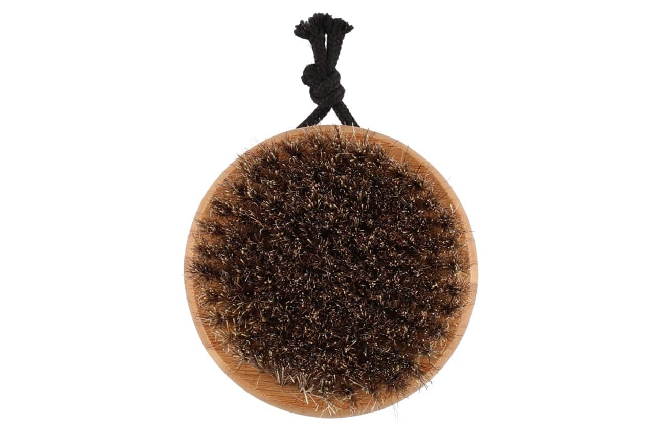 Bamboo body brush with natural bristles for skin care.
