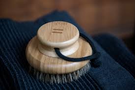 Bamboo body brush for skin care and exfoliation.