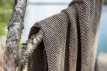 Brown sauna towel of 90x180 cm, made from soft and absorbent fabric.