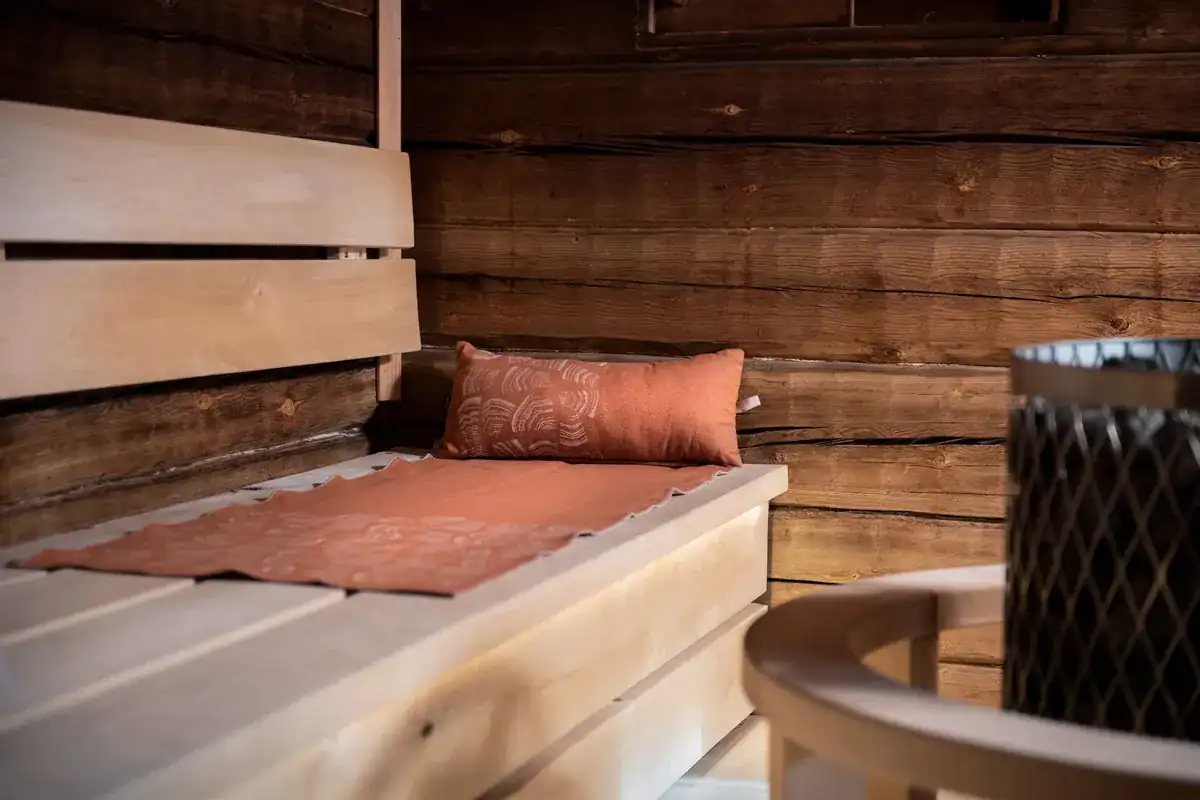 Brown Rento Pino sauna cushion on a wooden bench in a sauna.
