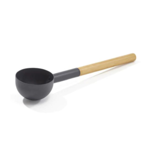 Black wooden sauna ladle for use in the sauna.