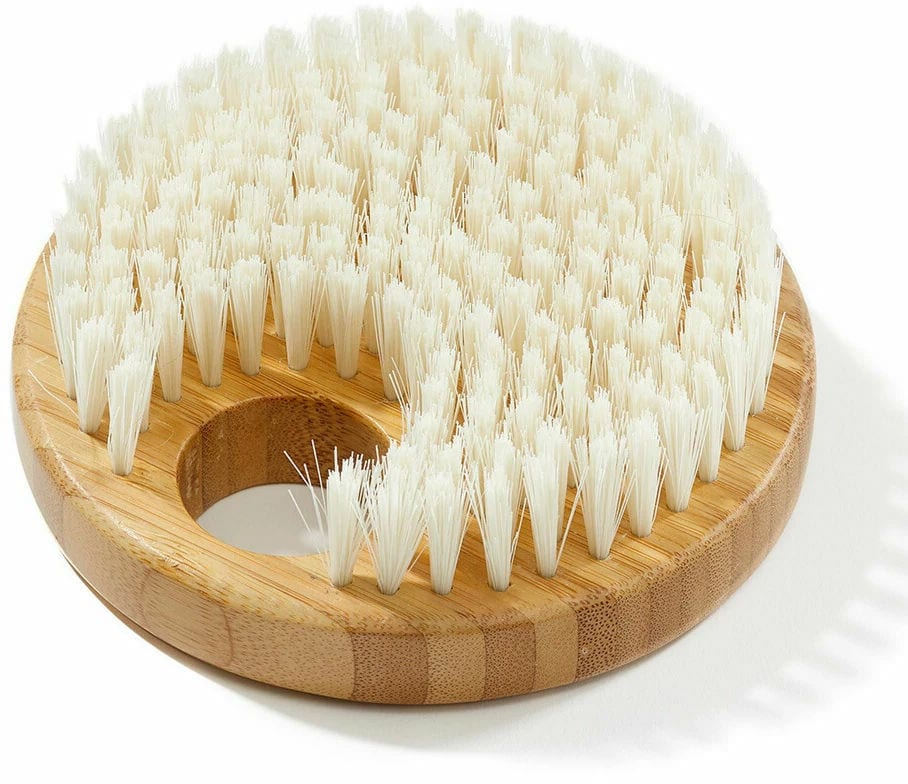 Round bamboo body brush with natural bristles for skin care.