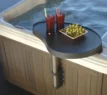 Black spa tray with drinks and grapes by the pool.