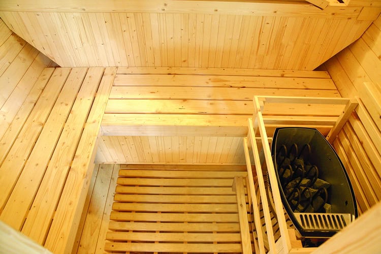 Outdoor sauna made of wood with infrared sauna and accessories.