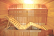 Wooden outdoor sauna with relaxation bench and accessories for 6 people.