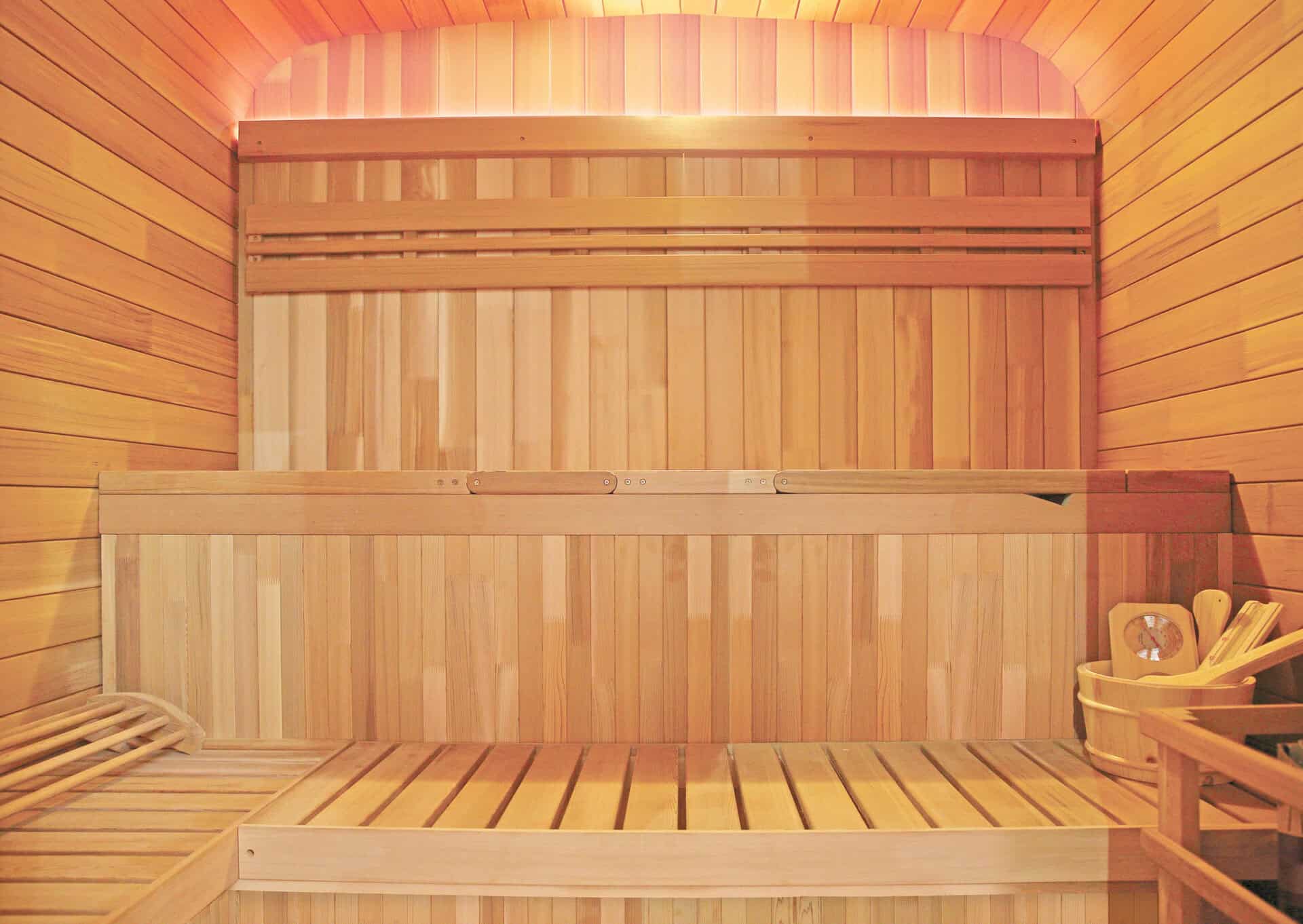 Outdoor sauna made of spruce wood with benches and accessories.