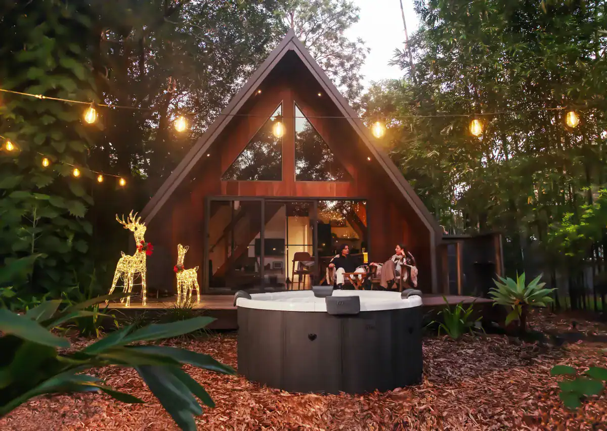 Luxury 6-person frame spa in the garden with atmospheric lighting.