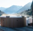 Rova frame spa for 6 people on a terrace with a mountain landscape.