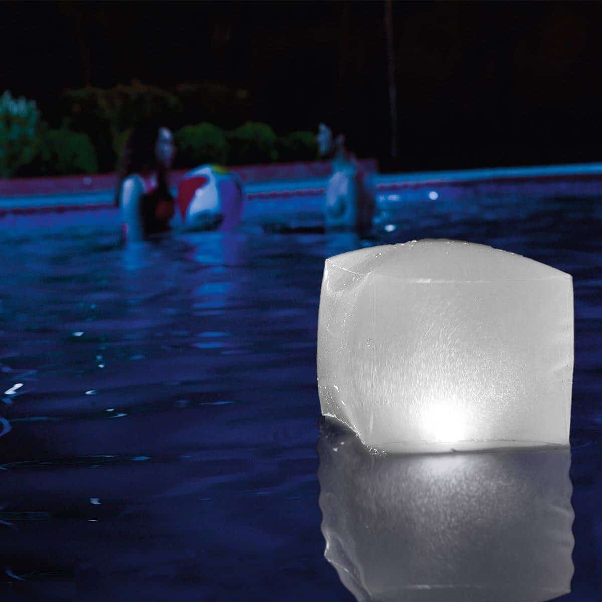 Pool ice block with swimming water in the background at night.